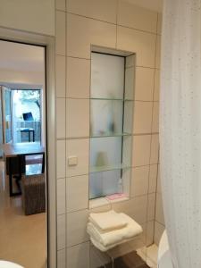 a bathroom with a shower with a mirror and towels at Stella Mare in Tučepi +54 photos