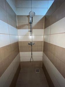 a shower with a shower head in a bathroom at Casa Marci Teo in Moieciu de Jos