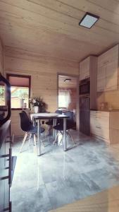 a kitchen and dining room with a table and chairs at Agroturystyka Rancho Łęg in Kruszyna +10 photos