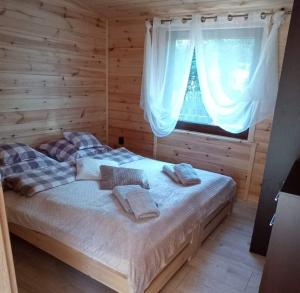 a bedroom with a bed in a log cabin at Agroturystyka Rancho Łęg in Kruszyna