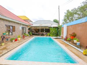 a swimming pool in the backyard of a house at Arusha Safari Hostel in Arusha