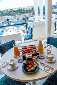 a table with a tray of food and drinks on it at Port Palace in Monte Carlo