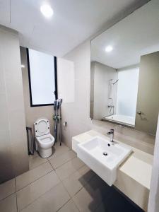 a bathroom with a sink and a toilet and a mirror at Connected train 3 Bedrooms - ABOVE KLGATEWAY MALL 14 in Kuala Lumpur