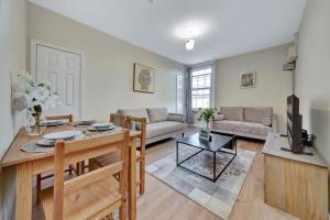 a living room with a table and a couch at Suites by Rehoboth - Makeba Suite - Dartford in Dartford