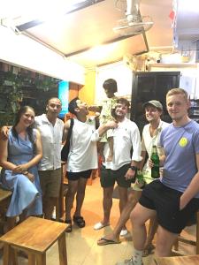 a group of people posing for a picture at Voyagers Hostel in Phi Phi Islands