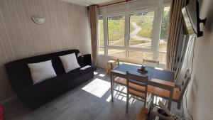 a living room with a couch and a table at Portillo in Puy-Saint-Vincent