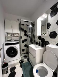 a bathroom with a toilet and a washing machine at RSA apartment - Comfort near City Centre in Bucharest