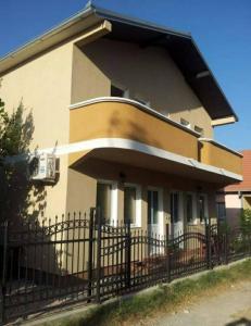 a house with a fence in front of it at Bojana Blue Retreat in Ulcinj