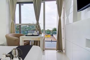 a hotel room with a bed and a large window at Grande Azure in Jaipur