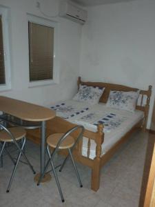 a bedroom with a bed and a table and chairs at Bojana Blue Retreat in Ulcinj