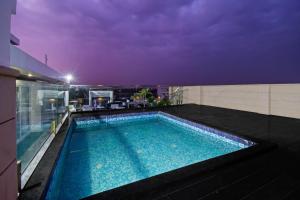 a swimming pool on the roof of a building at Grande Azure in Jaipur