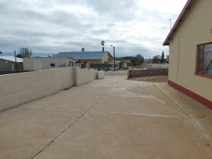 a concrete sidewalk next to a retaining wall at Klein Desert Song in Kleinsee