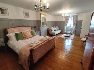 a bedroom with a bed and a living room at Les Houstalous in Lacombe