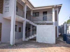 a building with two balconies on the side of it at Ekasi Apartments in Mbabane