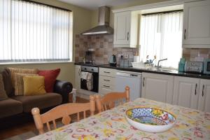 a kitchen with a table with a bowl on it at Cosy two bedroom cottage on the Mullet Peninsula in Ballina