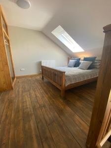 a bedroom with a bed and a skylight at Wee Kirkhill in Perth