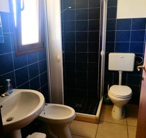 a bathroom with a toilet and a sink and a shower at TENUTA Li FRASULLI in Tuglie