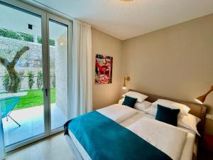a bedroom with a bed and a large window at IL SOGNO al Lago di Garda in Torri del Benaco