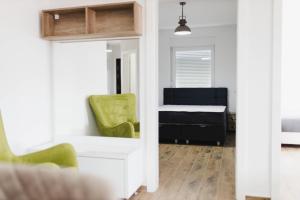 a bedroom with a bed and a mirror at Class Apartment in Brčko