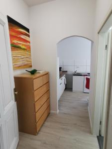 a kitchen with a dresser and a painting on the wall at Ferdimesse Apartments in Cologne +4 photos