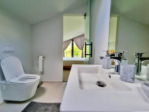 a white bathroom with a toilet and a sink at Casa Yla in Piatra Neamţ +75 photos