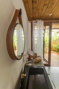 a bathroom with a mirror and a sink at MAYIM VILLA in Taipu