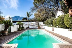 a swimming pool in the backyard of a house at Cape Dutch @ Keerweder in Franschhoek