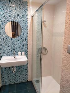 a bathroom with a shower and a sink and a mirror at Aixa Granada in Granada