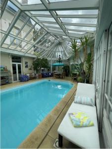 a large swimming pool with a bench next to it at Maison du Théâtre Saint Bonnet in Bourges