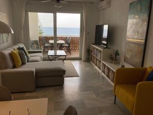 sala de estar con sofá y TV en Piso con vistas increibles del mar, en Almuñécar