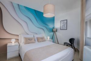 a bedroom with a bed and a blue and white wall at Apartments by the sea Malinska, Krk - 19227 in Malinska