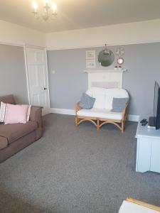 a living room with a couch and a bed at Ideally located Cumbrian home with stunning views in Seascale