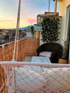 a hammock on a balcony with a view of a city at Finestra sulla Sicilia in Catania