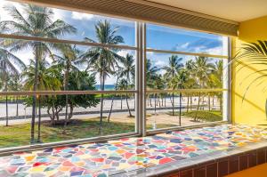 a room with a window with a view of the beach at Pelican Hotel in Miami Beach