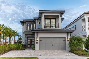 a house with a garage and palm trees at The Bear's Den Resort Orlando in Kissimmee