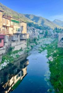 vista su un fiume in una città con edifici di Casa Via Orsini Isolabona Liguria Italy Sleeps 5 a Isolabona