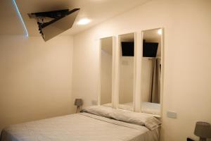 a bedroom with a bed and a mirror on the wall at Suite Daltmar Canyelles in Canyelles