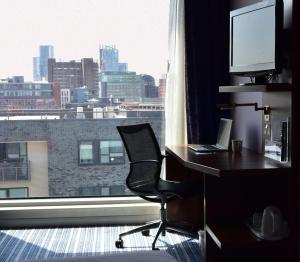 a room with a desk and a chair and a window at Holiday Inn Express Manchester City Centre Arena by IHG in Manchester