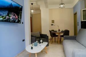 a living room with a couch and a table at Μοντέρνο Σπίτι στην καρδιά του κάστρου Ιωαννίνων in Ioannina