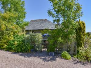 a wooden fence in front of a house at Parsonage Farm Cottage in Newton Ferrers