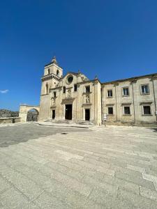 an old building with a tower on top of it at CASA VACANZE BB 164-166 in Matera