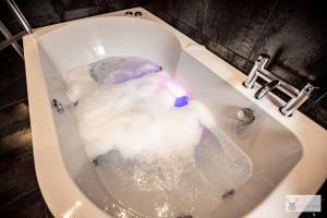 a bath tub filled with water in a sink at Silver Stag Properties Large 4 bed Property in Markfield +27 photos