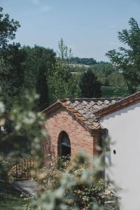 a brick building with a roof with a window at Borgo San Vincenzo in Montepulciano