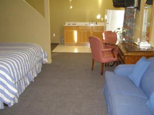 a bedroom with a bed and a desk and a couch at FIRST WESTERN INN in Caseyville +18 photos