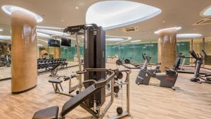 a gym with treadmills and ellipticals in a building at Oceanfront Beach Resort - SHA Extra Plus in Patong Beach