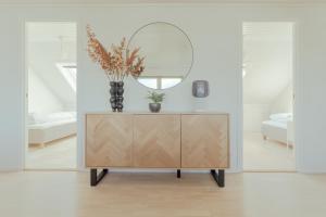 a mirror on top of a dresser in a room at 5 BR Penthouse Apartment / Downtown / Marina in Tórshavn