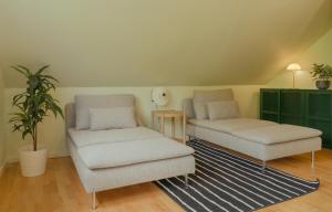 a living room with two chairs and a table at 5 BR Penthouse Apartment / Downtown / Marina in Tórshavn
