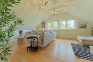 a living room with a couch and a table at 5 BR Penthouse Apartment / Downtown / Marina in Tórshavn