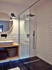 a bathroom with a glass shower and a sink at Madaras Házak 