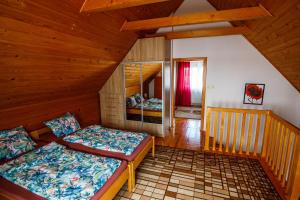 a bedroom with two beds in a cabin at Domek na skarpie in Rybno